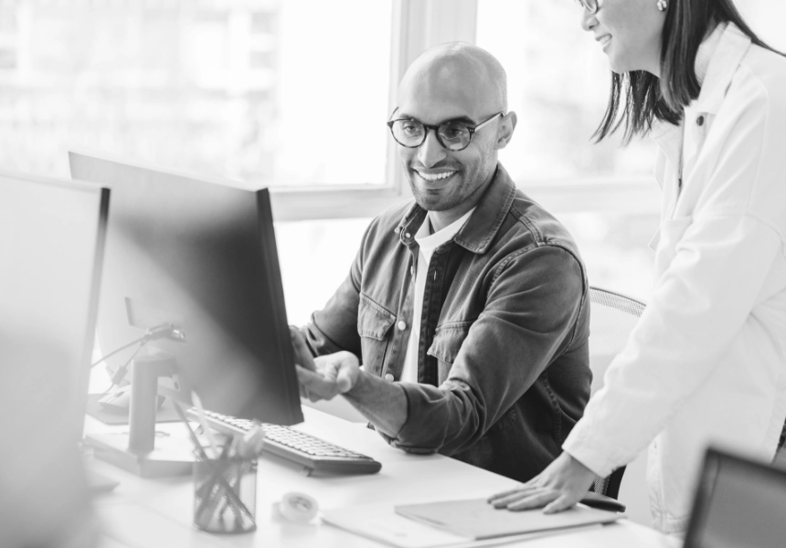 Person smiling while working on computer